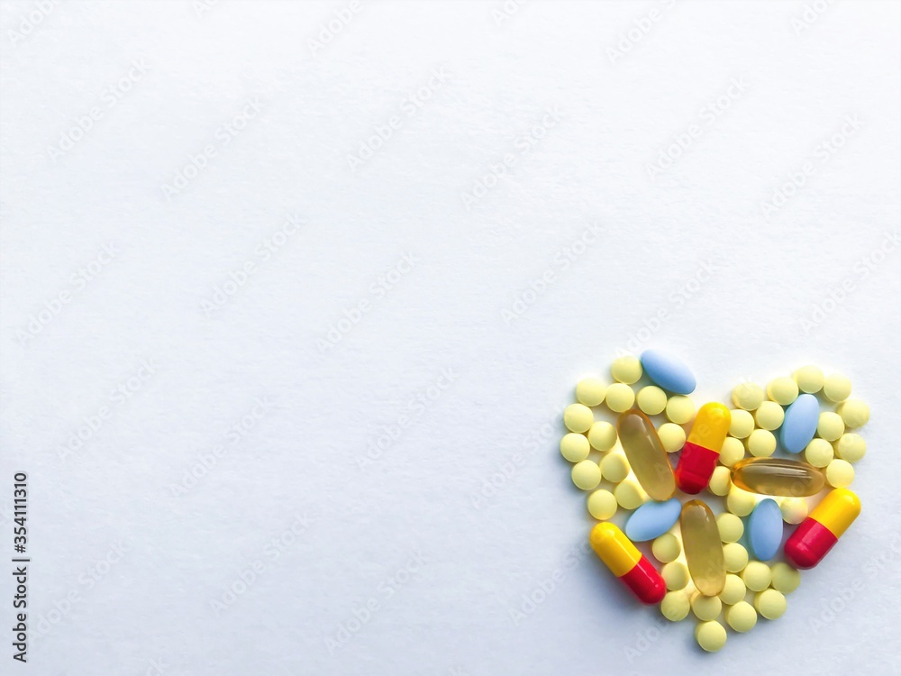 A lot of colorful tablets are laid out in the form of a heart