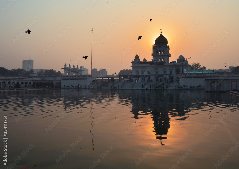 Gurudwara Bangla Sahib from the lake side at dawn, Delhi, India