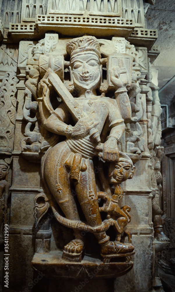 Fototapeta premium white marble God sculpture on a column in a temple, India