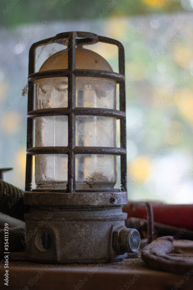 Old lantern by garage window.