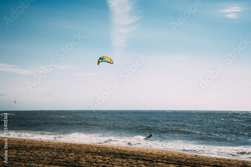 Kite surf in the ocean. A man doing kite surf. Paradise nature.