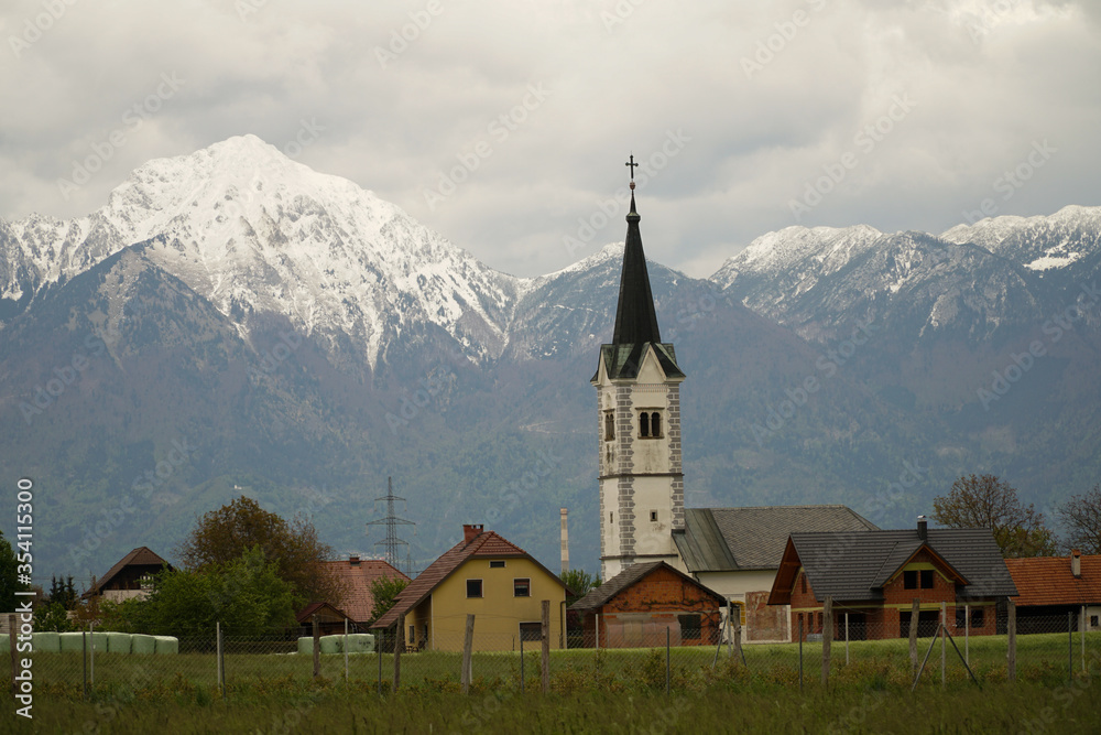 Rural village in Slovenia with Julian Alps background