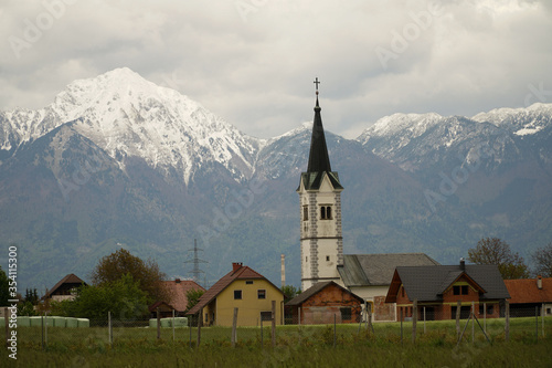 Rural village in Slovenia with Julian Alps background