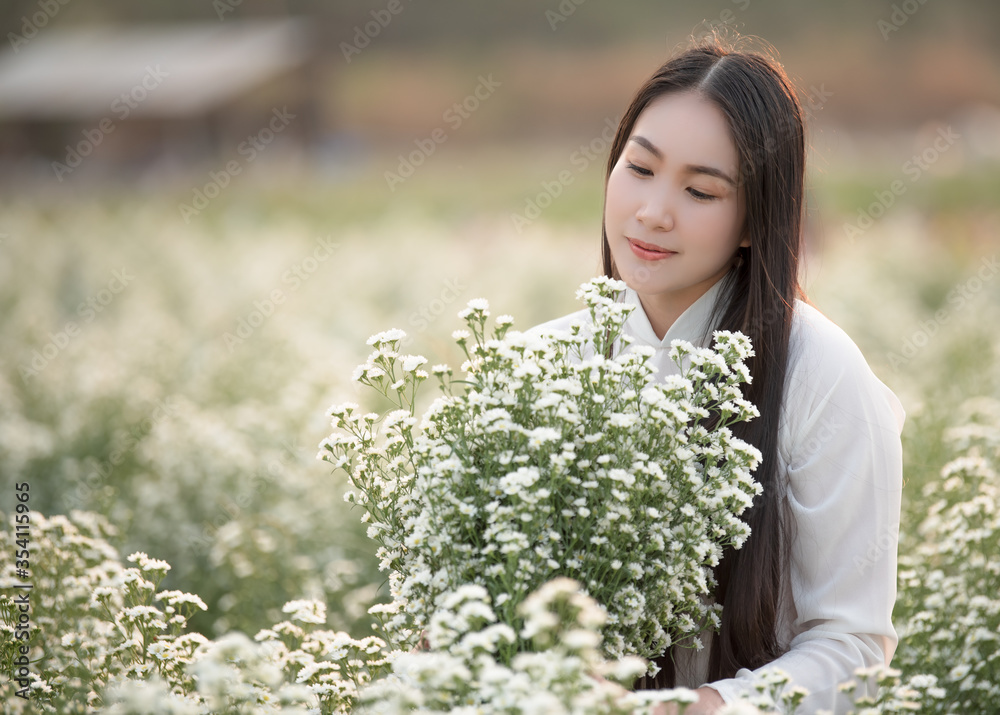 Beautiful Vietnamese girl in a flower garden Beautiful Vietnamese girl in a flower garden