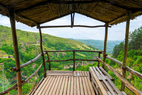 Fototapeta Naklejka Na Ścianę i Meble -  Wooden observation deck over the gorge in the picturesque mountains of Armenia