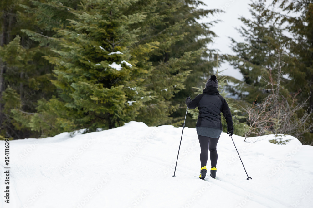 Cross country skier on a snowy mountain trail, in a winter sports scene