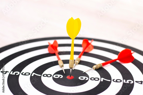 Right to Target Concept Using Darts in Bulseye on Darts Business Success Concept. destruction of competition. one arrow in bulseye, three red arrows fell