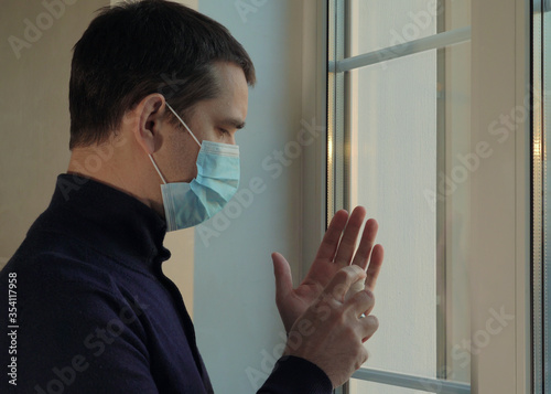 Man enters the house in a medical mask. Pandemic.