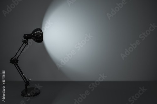 Black decorative lamps with empty desk background, 3d rendering.