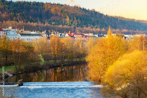 Houses in the city of Karlovy Vary on the Tepla river during sunrise in spring. Karlovy Vary Carlsbad is world famous for its mineral springs