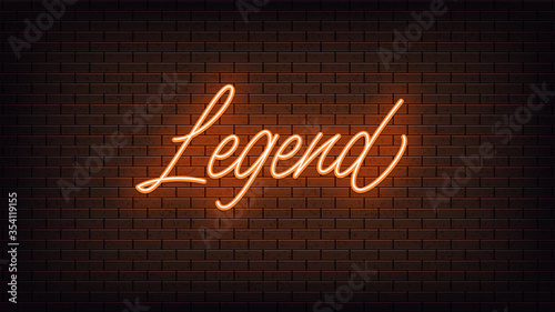 Orange neon Legend, lettering. Neon text of Legend on black brick background