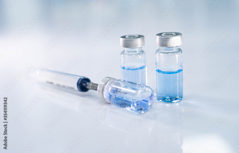 close up vaccine and syringe injection for prevention from virus infection close up vaccine and syringe injection for prevention from virus infection