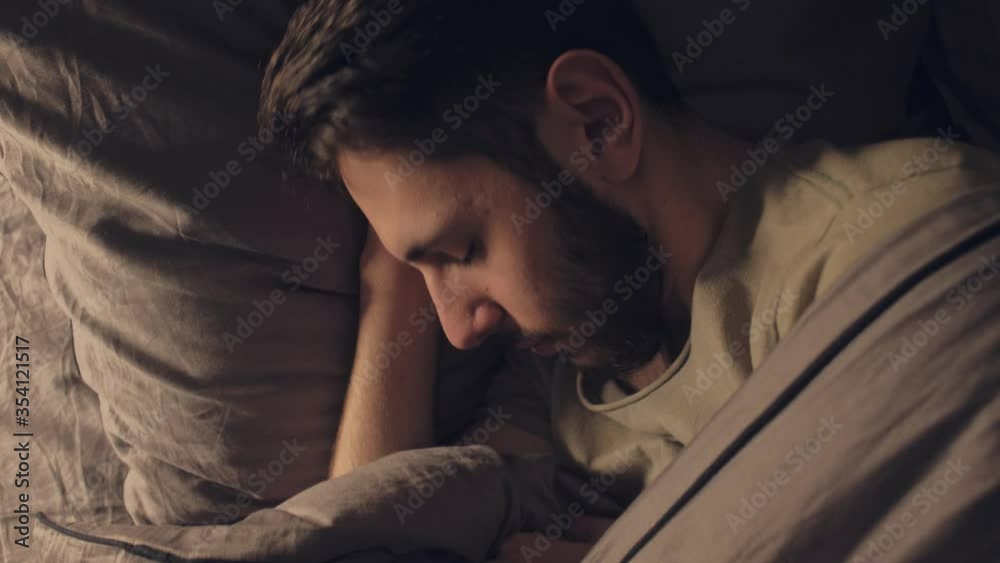 Restless night. Stress anxiety. Man woke up scared by nightmare in bed. Restless night. Stress anxiety. Man woke up scared by nightmare in bed.