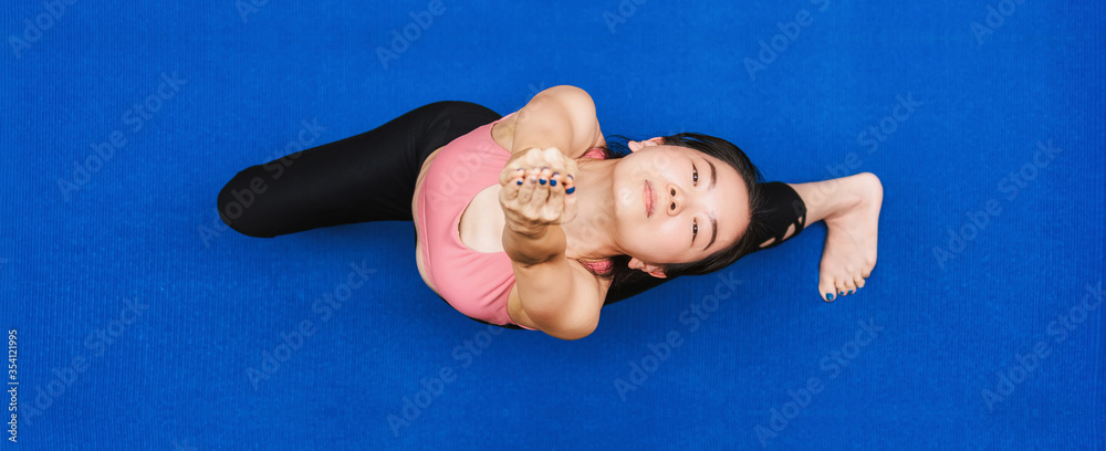 Banner of Top view Asian woman practicing yoga from home when Covid19 outbreak