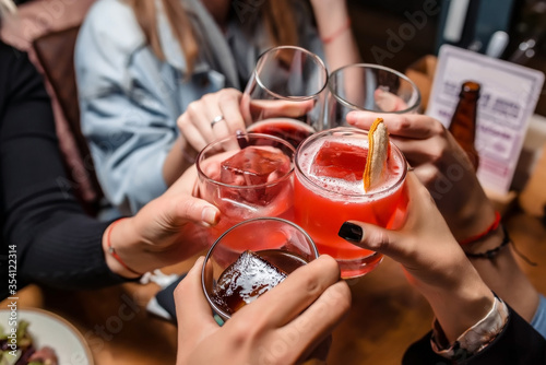 Photography The Friends are toasting with their drinks in hand during a party