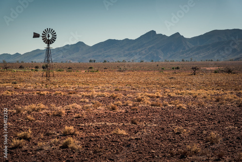 Windmill in front of Wilpena Pound at Flinders Ranges, South Australia photo