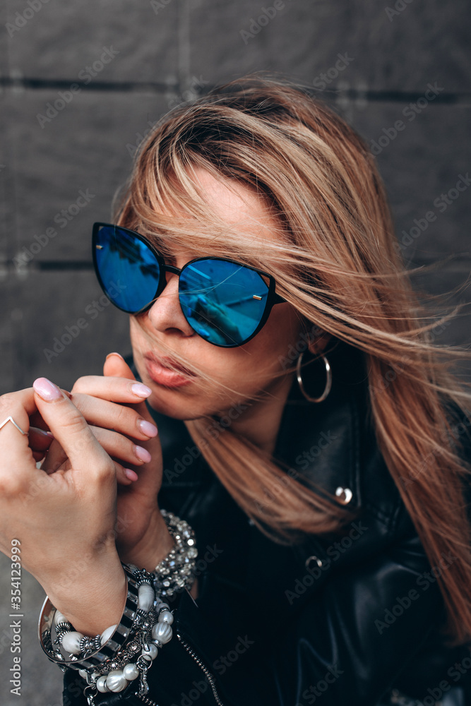 Portrait of a young girl. Photo session of a stylish girl outdoors.
Portrait of a young girl. Photo session of a stylish girl outdoors.