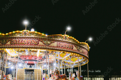 Newcastle/UK 13th Nov 2019: Merry go round lights during a cold foggy winter night © GraemeJBaty