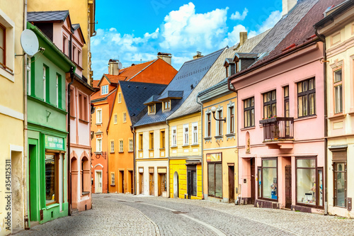 Small town narrow street view with colorful houses in Loket, Bohemia during sunny day. Czech Republic old town.