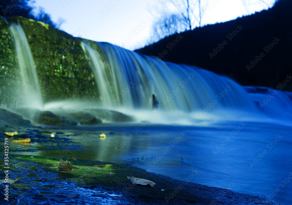 Fototapeta premium view on waterfall while playing with flashlight