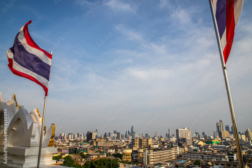  thai flag and Bangkok cityscape from Wat Saket Ratcha Wora Maha Wihan (Wat Phu Khao Thong, Golden Mount temple), a popular Bangkok tourist attraction, Thailand