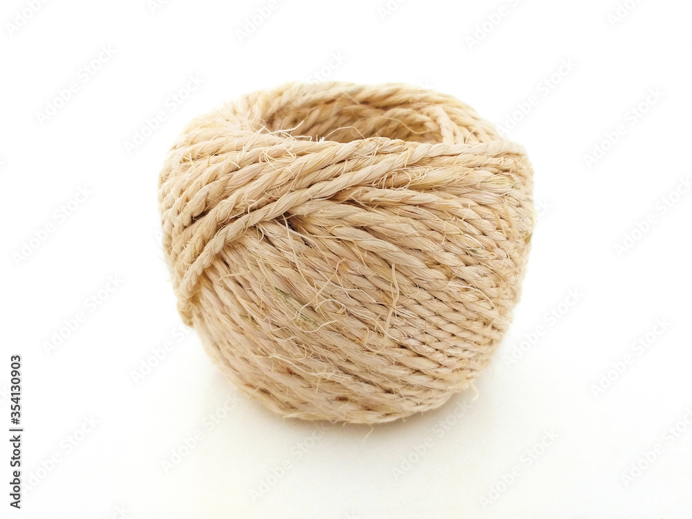 High quality handmade natural hemp rope coil isolated on white background. Rustic beige cord of natural composition respectful with the environment. Jute rope Ecofriendly