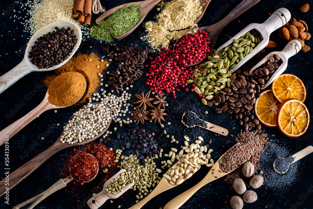 Many spices and herbs on the dark background table - obrazy, fototapety, plakaty 