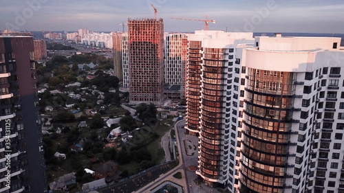 Modern residential building under construction. Construction site aerial view at sunset. coseup windows. Drone shot.  photo