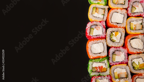 Sushi rolls with cucumber and avocado with raw vegetables food border background