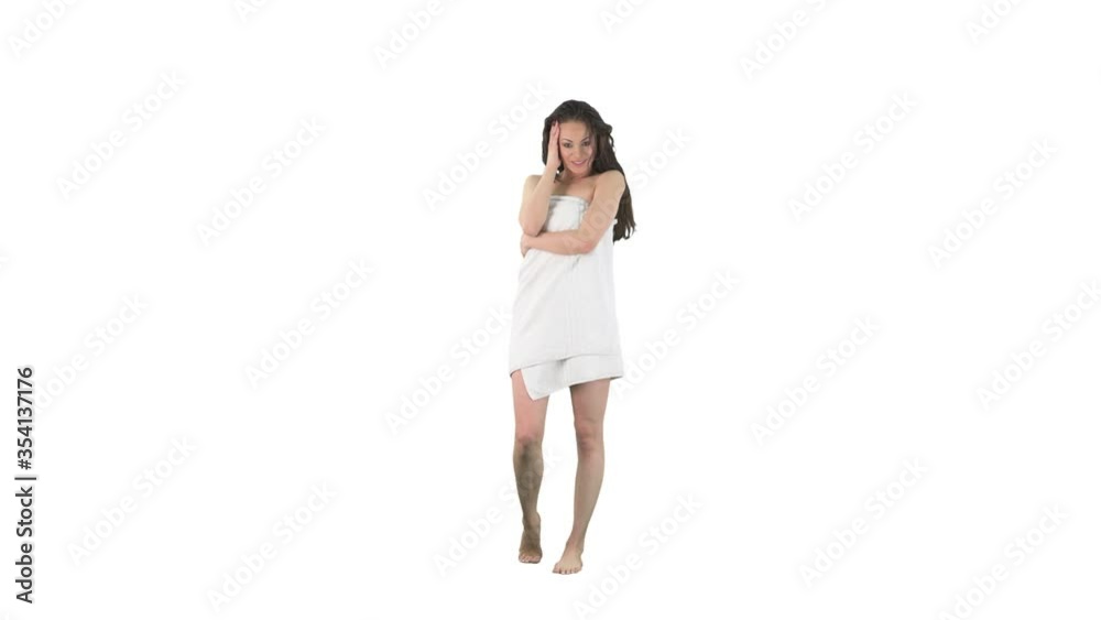 Back view of happy young woman wrapped in towel after taking shower turning around smiling at camera and posing isolated on solid white background. Back view of happy young woman wrapped in towel after taking shower turning around smiling at camera and posing isolated on solid white background.