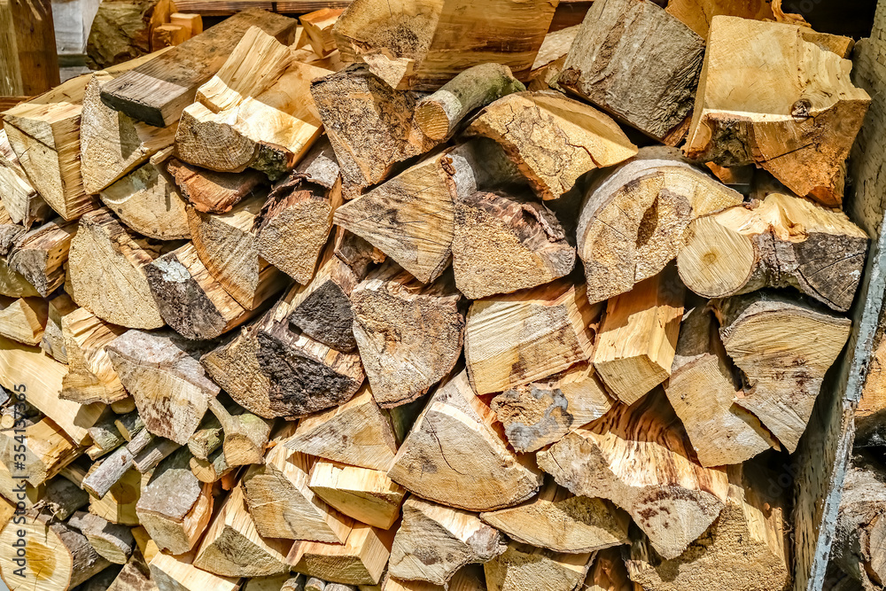 Close up of chopped logs stacked up in a fire wood pile Close up of chopped logs stacked up in a fire wood pile
