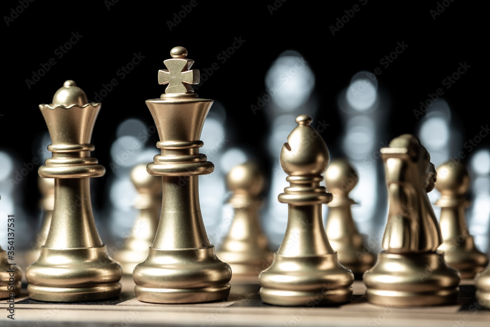 gold against silver chess pieces team on chess board, business strategy concept gold against silver chess pieces team on chess board, business strategy concept