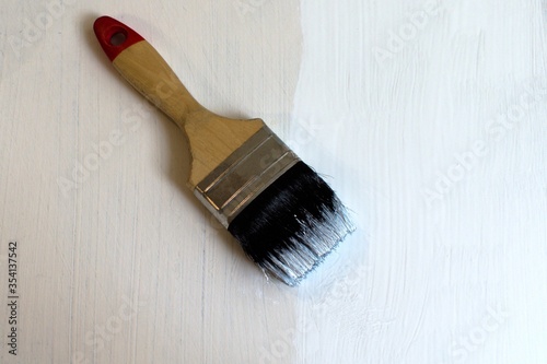 paintbrush on a white painted panel