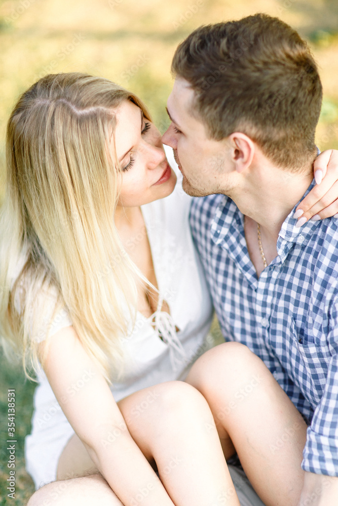 Romantic date in the Park. Beautiful young couple hugging in the rays of the evening sun. Romantic date in the Park. Beautiful young couple hugging in the rays of the evening sun.