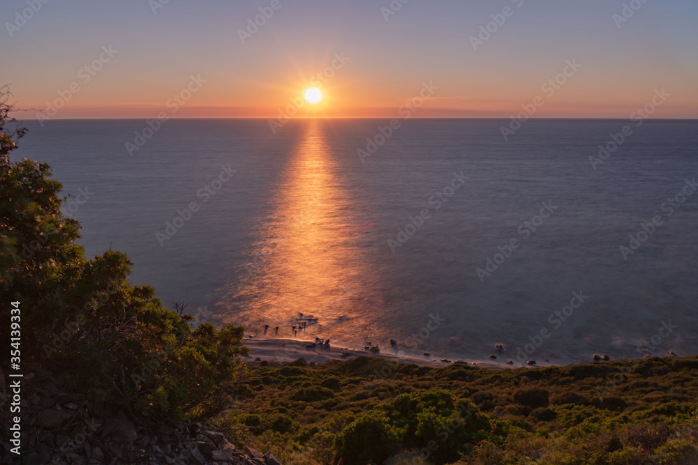 Sunset over the sea and the coastline of the Mediterranean island of Corsica