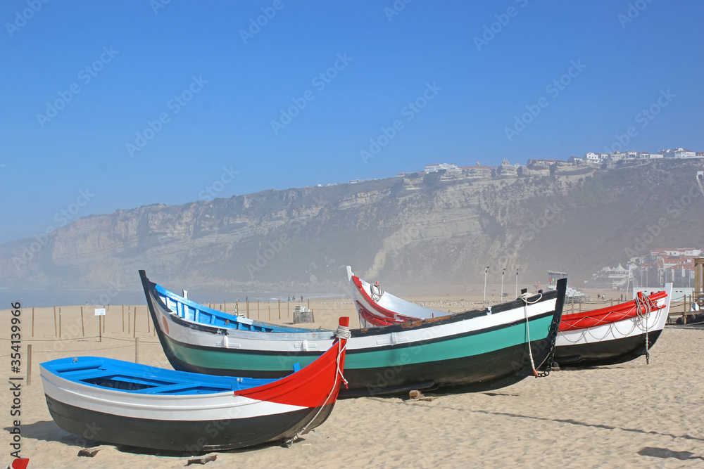 Traditional fishing boats on Nazare beach, Portugal	