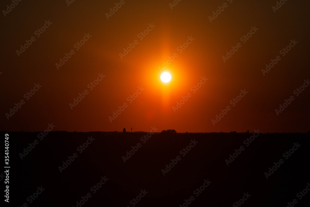 Golden fire sunset above the horizon.