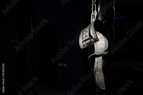 BDSM Leather handcuffs for role-playing games on a black background. Bondage for carnal pleasures. Domination and submission. © Михаил Решетников