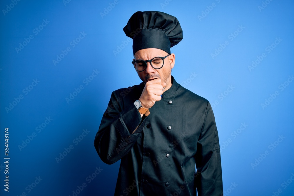 Young handsome chef man wearing cooker uniform and hat over isolated blue background feeling unwell and coughing as symptom for cold or bronchitis. Health care concept. Young handsome chef man wearing cooker uniform and hat over isolated blue background feeling unwell and coughing as symptom for cold or bronchitis. Health care concept.