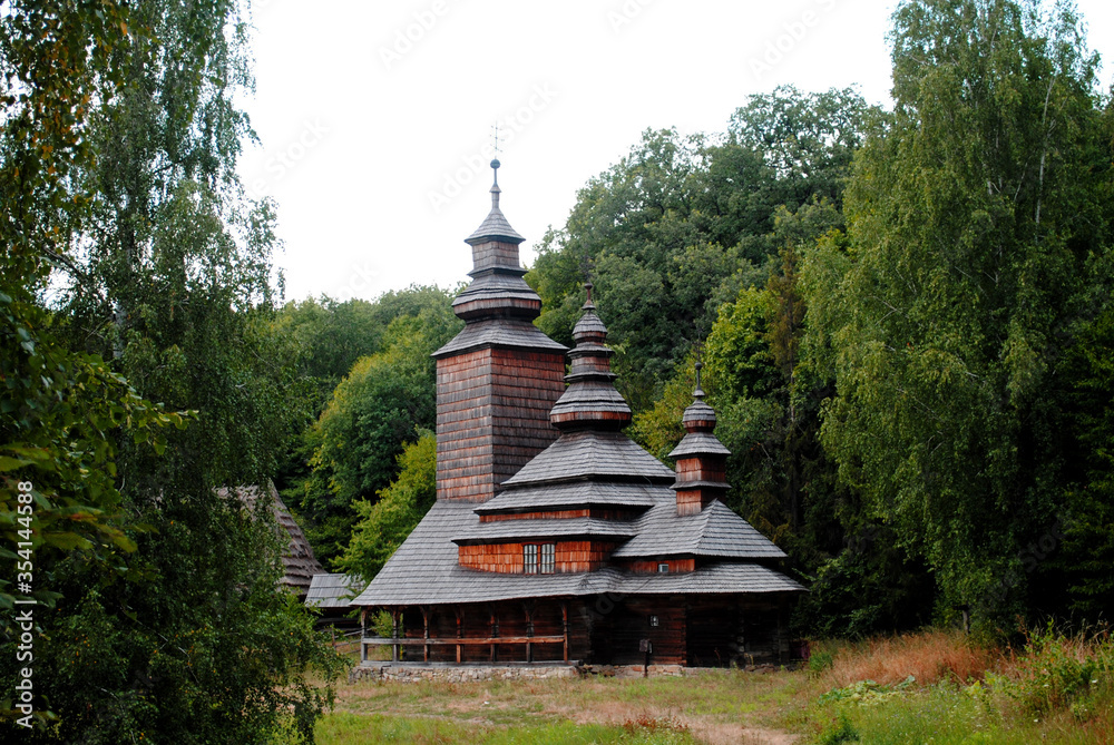 Ethnic-style wooden church against a tree background Ethnic-style wooden church against a tree background