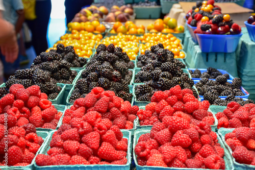 Beautiful fresh raspberries and blackberries at Granville Island Market in Vancouver, BC.