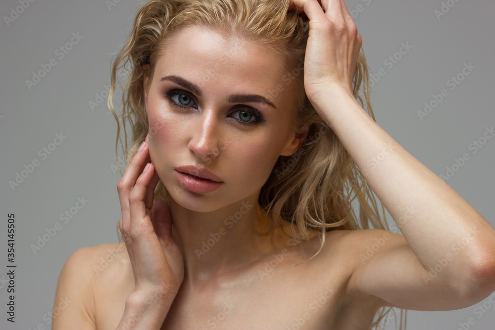 Fototapeta premium Beauty Woman face with hand Portrait. Beautiful model Girl with Perfect Fresh Clean Skin color lips purple red. Blonde long hair Youth and Skin Care Concept. Isolated on a white background
