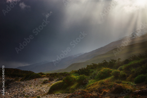 Dramaticlandscape, with a large water storm and the rays of the sun rising through the clouds. On a walk near Posadas Lake, Argentina