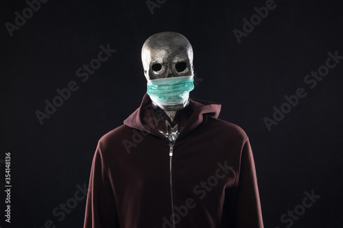Fototapeta Naklejka Na Ścianę i Meble -  monster in a medical mask in a hood