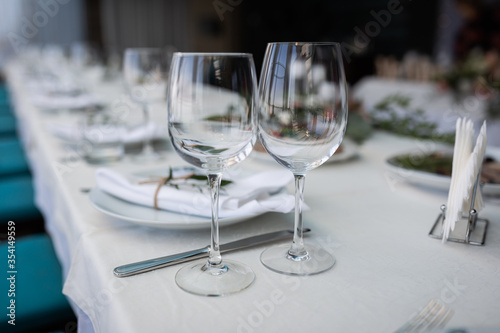 wedding table setting. two empty glasses in the foreground