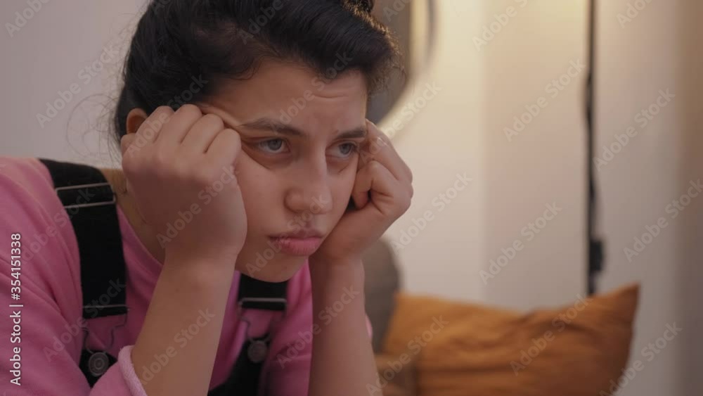 Young lovely girl watch at tv screen enjoying movie. woman sitting in living room comfortable sofa. lady relaxing in the evening and home watching TV. Young lovely girl watch at tv screen enjoying movie. woman sitting in living room comfortable sofa. lady relaxing in the evening and home watching TV.