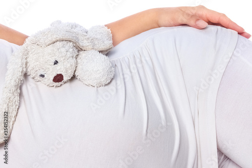 Happy pregnant girl lies on white background