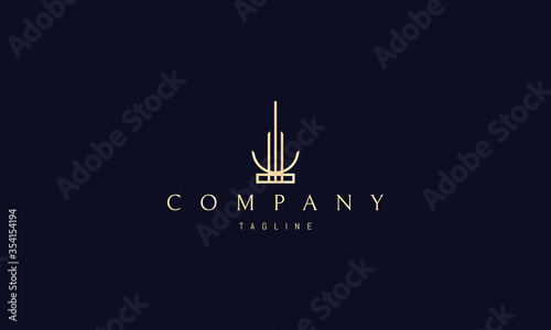 Vector golden logo on which an abstract image of a tall tower with an inverted moon at the base.