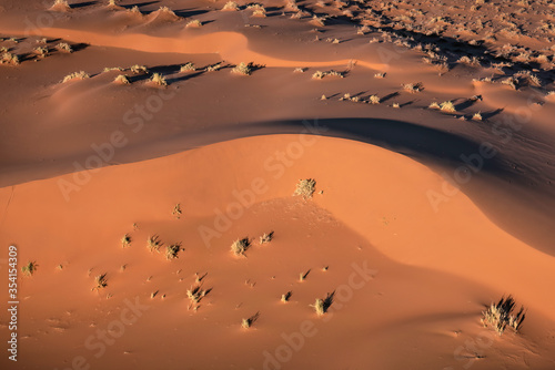 Aerial view of the sand dunes, located in the Namib Desert, in the Namib-Naukluft National Park, Namibia at sunrise.