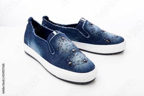 casual denim shoes isolated on a white background, denim sneakers close-up